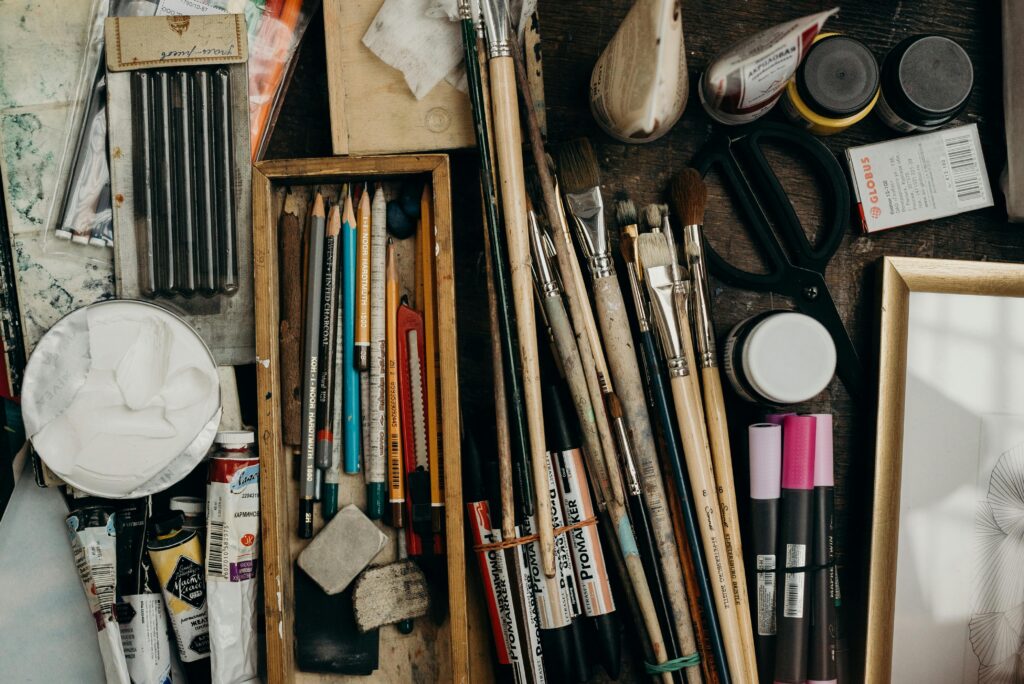 Top view of various art supplies on a desk, showcasing creativity tools.